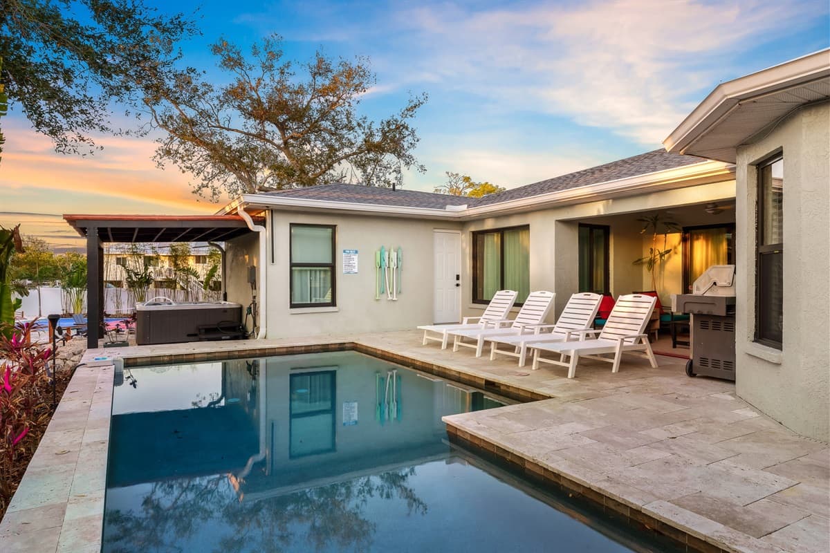A stunning private pool area. Featuring a sparkling pool, comfortable sun loungers, and lush tropical landscaping, this outdoor oasis is a feast for the senses.
