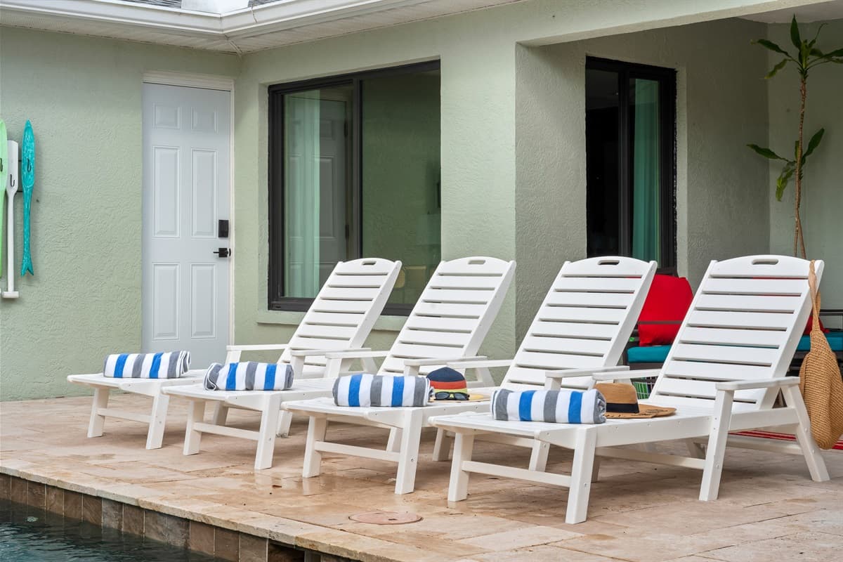 Poolside Lounging. Unwind on comfortable loungers by the pool, perfect for soaking up the sun or enjoying a relaxing afternoon with family.