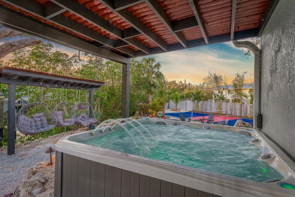 Indulge in the luxurious experience of our private hot tub, nestled beneath a shaded pergola. It's the ideal setting for ultimate relaxation and serenity.