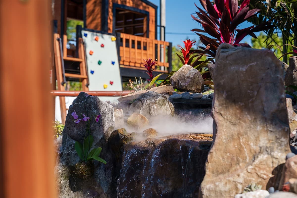 Find peace and tranquility at our outdoor pond. Surrounded by lush greenery and natural stone, it's the perfect spot to relax and enjoy the beauty of nature.