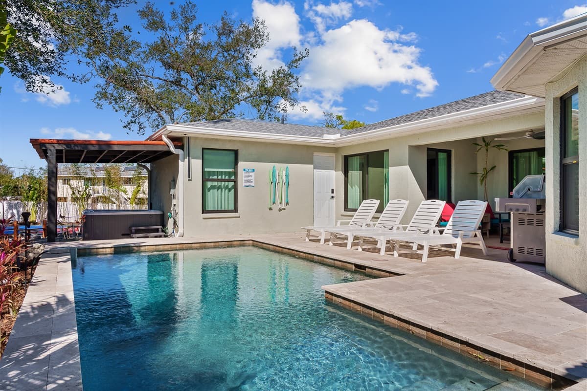 A stunning private pool area. Featuring a sparkling pool, comfortable sun loungers, and lush tropical landscaping, this outdoor oasis is a feast for the senses.